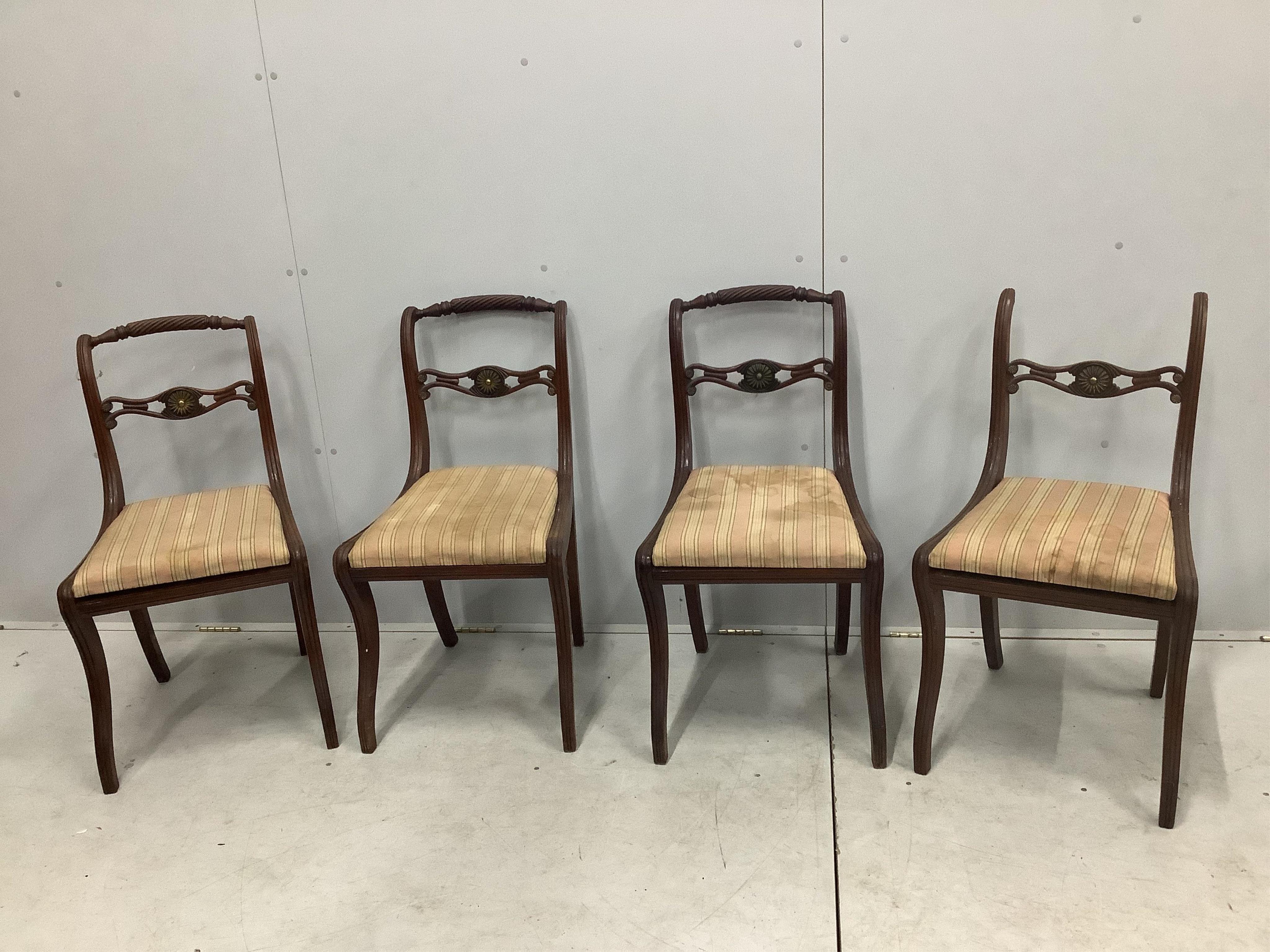 A set of eight Regency brass mounted mahogany dining chairs, one with arms. Condition - poor to fair, one lacking top rail